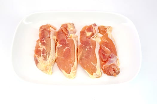 Fresh slices of chicken isoloate on white background ready to be grilled.