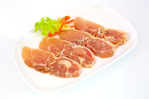 Fresh slices of chicken isoloate on white background ready to be grilled.