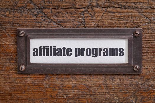 affiliate programs l  - file cabinet label, bronze holder against grunge and scratched wood