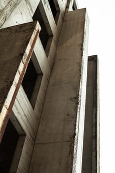 Concrete wall with window openings of the unfinished building