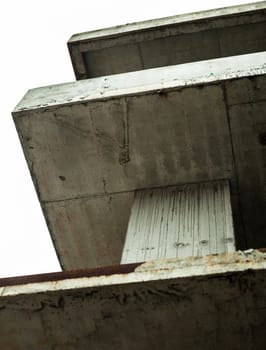 Concrete surfaces of the unfinished building against the white sky
