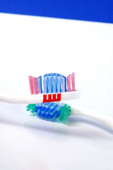 close up  of blue tooth  and green brush, picture of a 