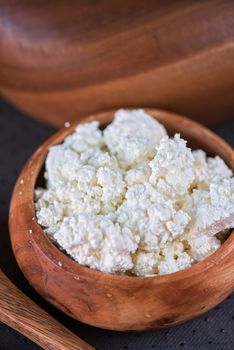 curd in brown wooden bowl closeup