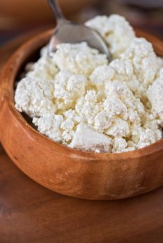 curd in brown wooden bowl closeup