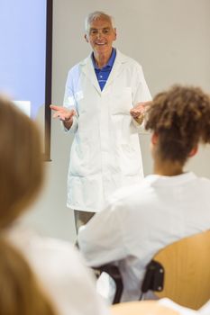Science professor giving lecture to class at the university