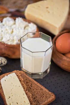 still life with dairy products as milk, cheese cottage cheese eggs and bread 