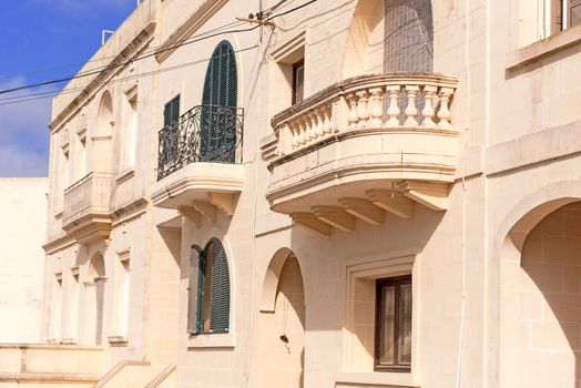 Facade of residential building with balcony on Gozo Island, Malta