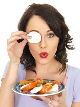 Young Healthy Woman Eating a Mozzarella Cheese and Tomato Salad