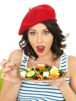 Young Healthy Woman Eating a Fresh Crispy Greek Salad