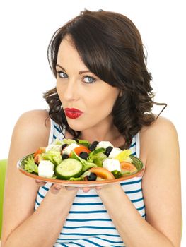 Young Healthy Woman Eating a Fresh Crispy Greek Salad