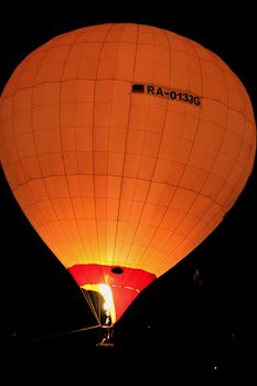 Hot air baloon starting to fly in the evening sky