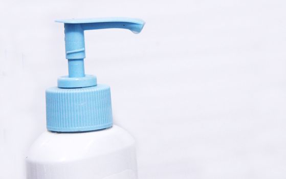 White and blue dispenser on the bottle of cleaning liquid