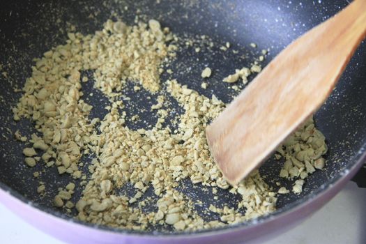 Green coffee roasting on the black pan