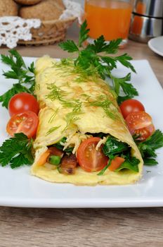 Omelet stuffed with vegetables  herbs and tomatoes