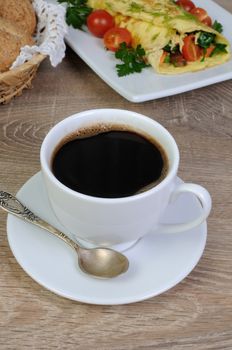 Cup of black coffee for breakfast with scrambled eggs