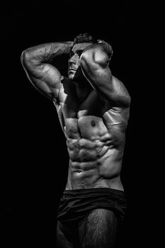 bodybuilder, posing on a black background