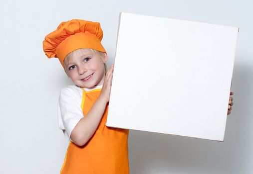 Portrait of the little cook with a box for pizza