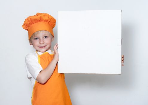 Portrait of the little cook with a box for pizza