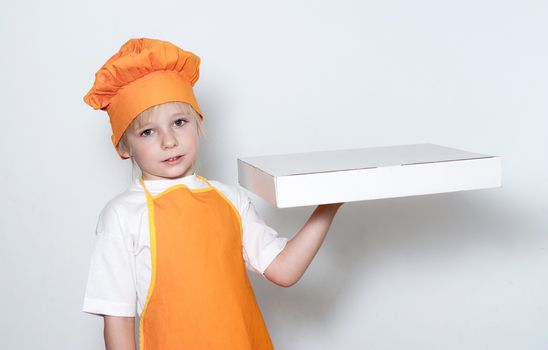 Portrait of the little cook with a box for pizza