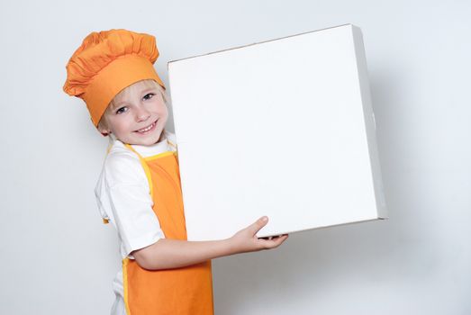 Portrait of the little cook with a box for pizza