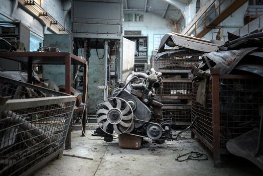 The image of an used engine in empty factory