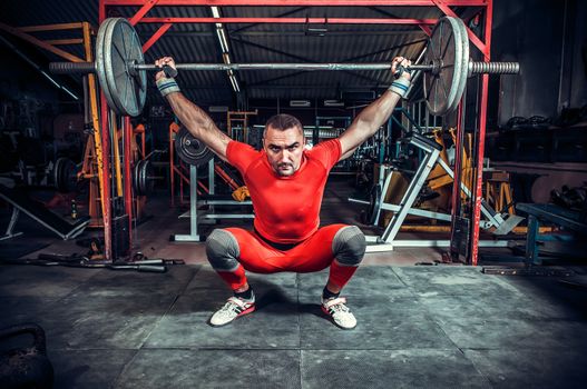 Powerlifter with strong arms lifting weights