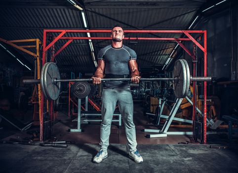 Powerlifter with strong arms lifting weights