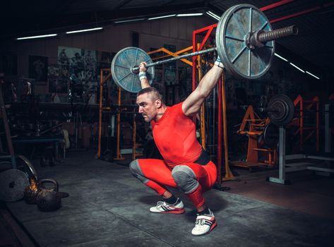 Powerlifter with strong arms lifting weights