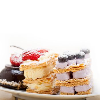 selection of fresh cream napoleon and chocolate mousse cake dessert plate 