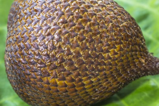 Snake Fruit and Green Leaf on the Wood Table.