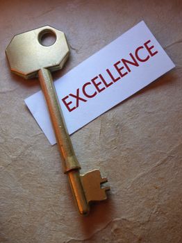 Close up of a golden key with excellence label 