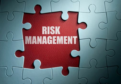 Missing pieces from a jigsaw puzzle revealing risk management