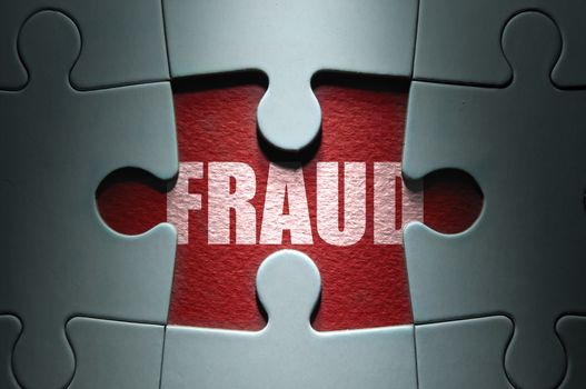 Missing piece from a jigsaw puzzle revealing the word fraud
