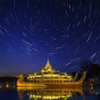 Star trails above the Karaweik, a replica of a Burmese Royal Barge on Kandawgyi Lake in Yangon in Myanmar. Although a national landmark it now houses a restaurant.