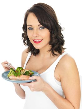 Healthy Young Woman Eating Salmon and Vegetables