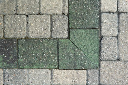 Overhead view of the corner pattern in ornamental grey brick paving on an outdoor patio or garden landscaping