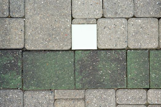 Fiber optic light in a brick paved patio with ornamental brickwork and a darker border viewed from above in an architectural background