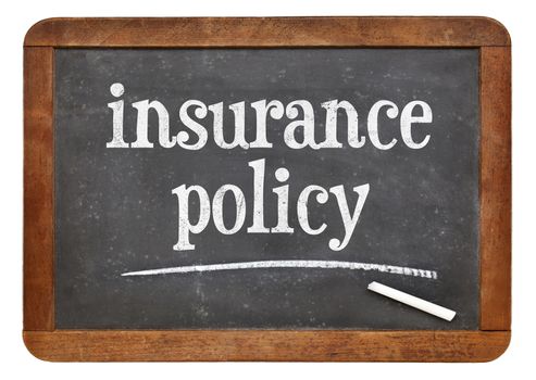 insurance policy text on  a vintage slate blackboard