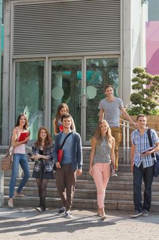 Happy students walking and smliling outside at the university