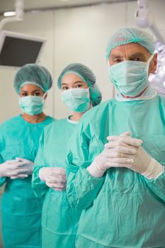 Medical student and lecturer looking at camera in scrubs at the university