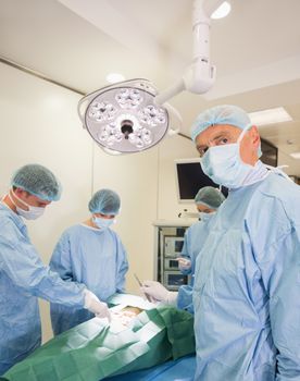 Medical student looking at camera during practice surgery at the university