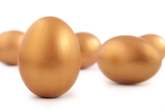 Many gold eggs over a white background 