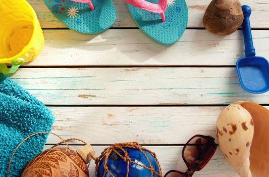 Travel beach items over wood panels 