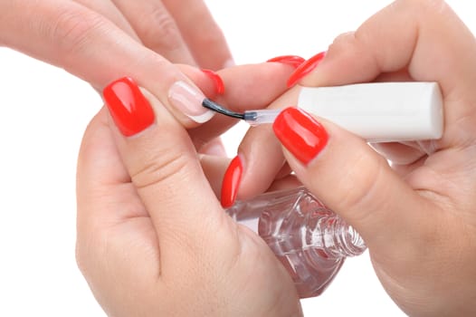 manicure applying, brushing fingernails with clear enamel