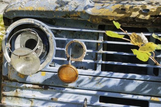 Old truck front closeup, falling apart from a lack of care and interest.  Rodneys Place, old school buses.