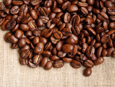 Background from coffee beans on fabric closeup     