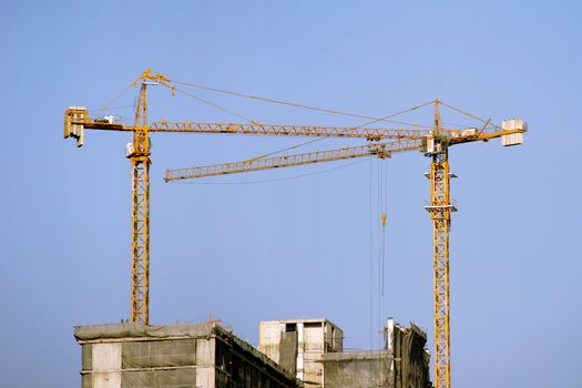 Working crane against blue sky