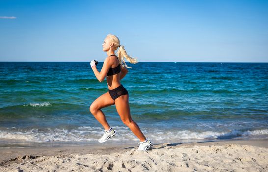 Running woman. Female runner jogging during outdoor workout on beach