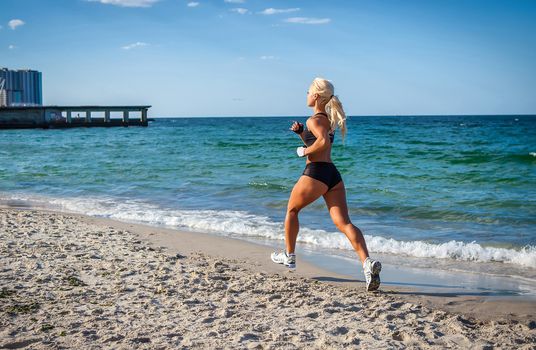 Running woman. Female runner jogging during outdoor workout on beach