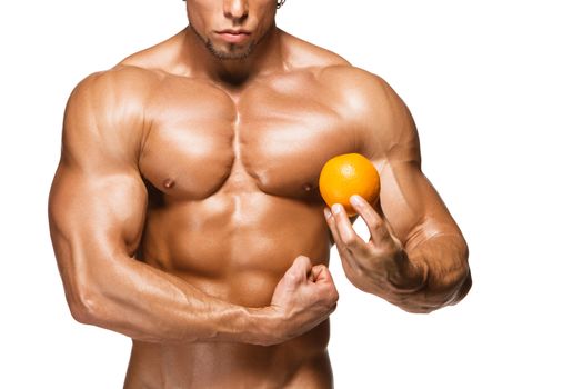 Shaped and healthy body man holding a fresh orange fruits, isolated on white background